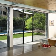 Bi fold screen double doors opening into lawn and pool area