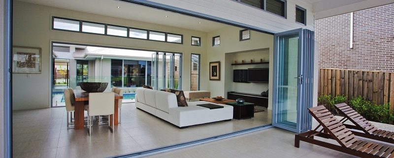 Open bi-fold doors opening into large living room with dining area