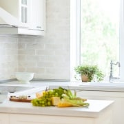 White bi fold windows over a sink in a modular kitchen