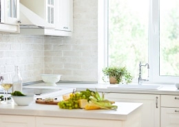 White bi fold windows over a sink in a modular kitchen