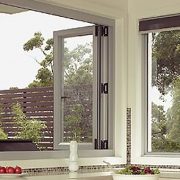 Open white frame aluminium bi-fold windows in a kitchen