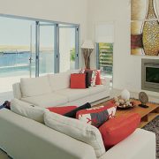 Bi fold doors open into balcony of a living room with contemporary decor