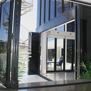 Tinted aluminium bi fold doors at the entrance of a house