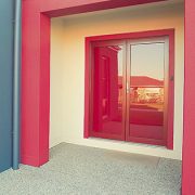 Red frame french hinged doors in a house