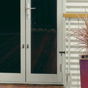 Colourful plant pot next to white framed french hinged doors
