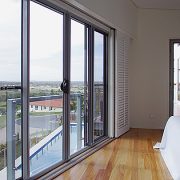 Bedroom with white bed & sliding doors