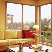Living area with tall aluminium windows looking into the garden