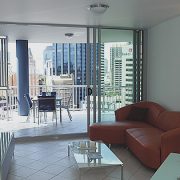 Sliding doors in a living room opening to balcony overlooking the city