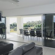 Living room with stacker doors opening into balcony area