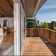 Angular view of timber balcony opening into living space